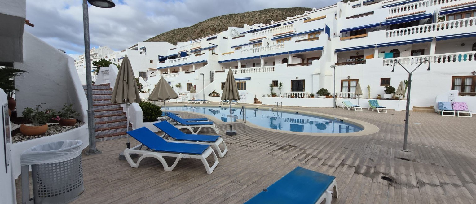 Port Royale 285, the pool and white buildings in a wide view of the complex