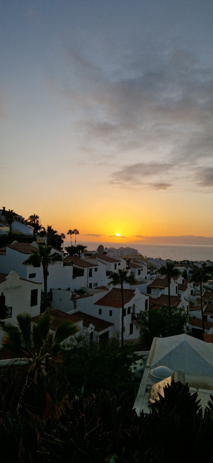 Sunset above white houses and the ocean in Tenerife